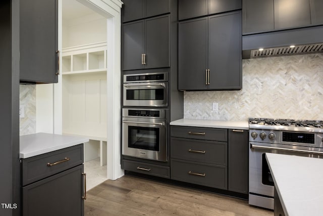 8620 Dukes Lake Rd, Zebulon, NC 27597 - kitchen featuring stainless steel appliances, custom range hood, decorative backsplash, and light countertops
