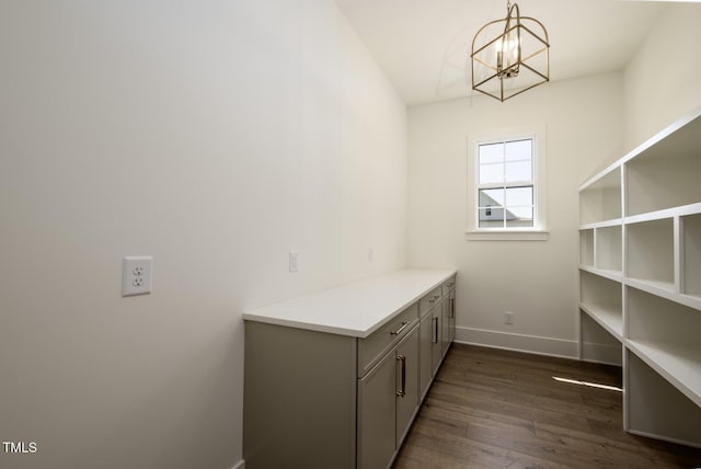 8620 Dukes Lake Rd, Zebulon, NC 27597 - laundry area with a chandelier and dark wood finished floors