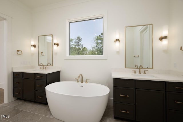 8620 Dukes Lake Rd, Zebulon, NC 27597 - bathroom featuring two vanities, a freestanding bath, and tile patterned floors
