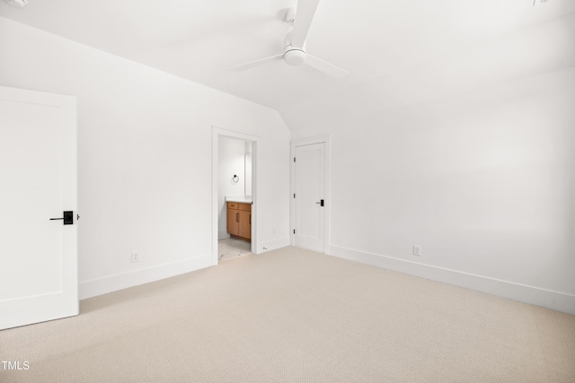 8620 Dukes Lake Rd, Zebulon, NC 27597 - unfurnished bedroom with light colored carpet, connected bathroom, ceiling fan, and lofted ceiling