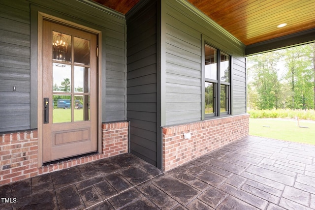 8620 Dukes Lake Rd, Zebulon, NC 27597 - doorway to property featuring brick siding and covered porch
