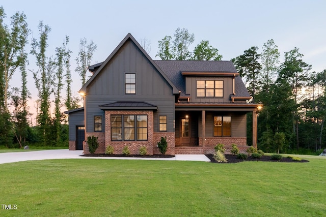 8620 Dukes Lake Rd, Zebulon, NC 27597 - view of front of house with brick siding, a porch, a lawn, board and batten siding, and a standing seam roof