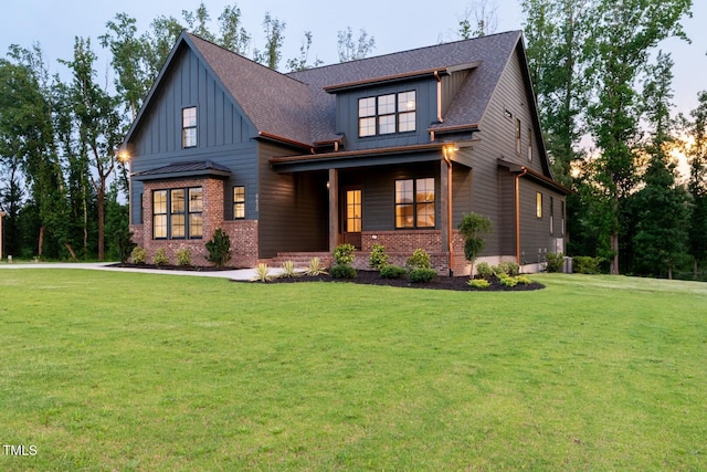 8620 Dukes Lake Rd, Zebulon, NC 27597 - craftsman inspired home featuring board and batten siding, brick siding, a front yard, and a shingled roof