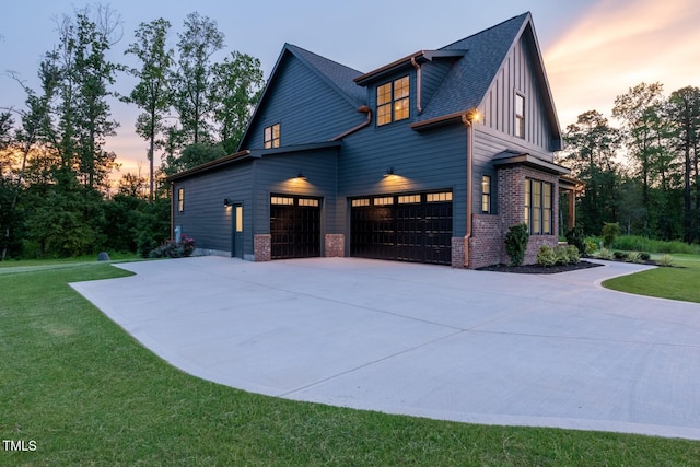 8620 Dukes Lake Rd, Zebulon, NC 27597 - property exterior at dusk with concrete driveway, a yard, brick siding, and an attached garage