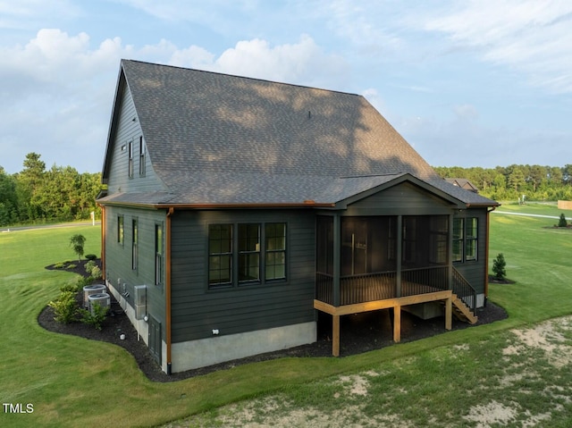 8620 Dukes Lake Rd, Zebulon, NC 27597 - rear view of house with roof with shingles, a sunroom, and a yard