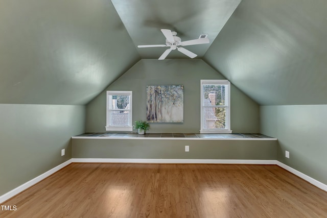 bonus room with vaulted ceiling, a ceiling fan, wood finished floors, and visible vents