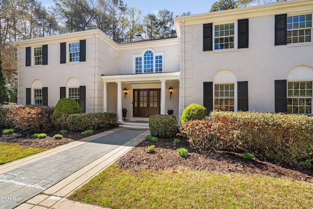 view of front of property featuring brick siding and french doors