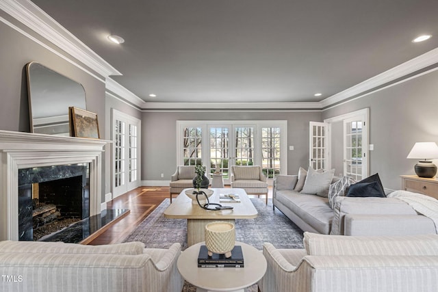 100 Dunedin Ct, Cary, NC 27511 - living room with crown molding, wood finished floors, plenty of natural light, baseboards, and a high end fireplace
