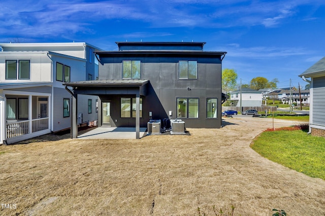 rear view of property featuring central air condition unit and a patio