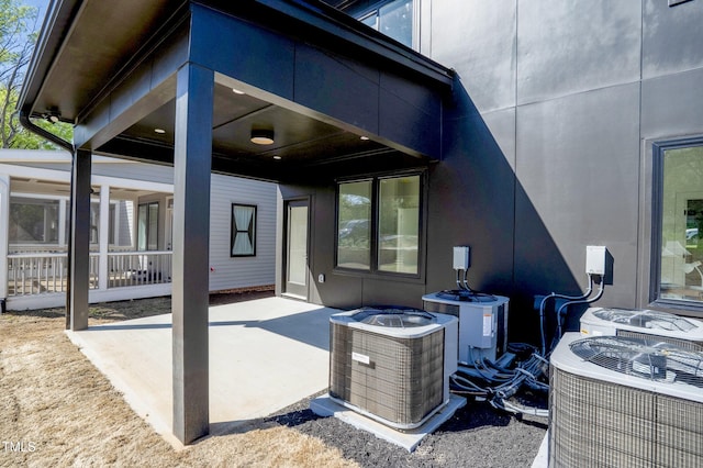 back of property featuring a patio and central AC