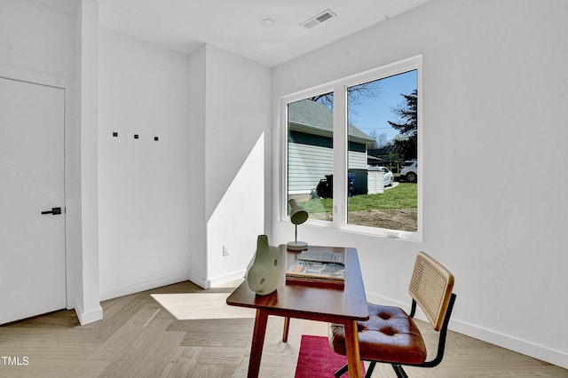 home office with baseboards, visible vents, and wood finished floors