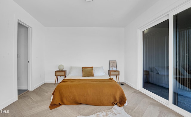 bedroom featuring access to outside and baseboards