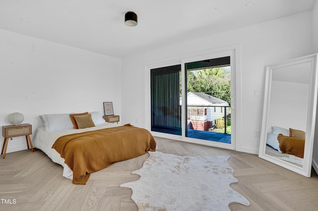 bedroom featuring access to outside and baseboards