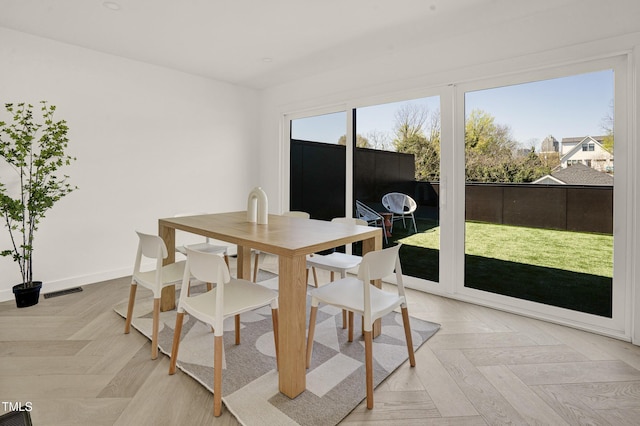 dining space with baseboards and visible vents