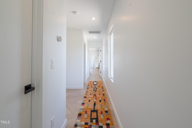 hallway featuring visible vents, baseboards, and recessed lighting
