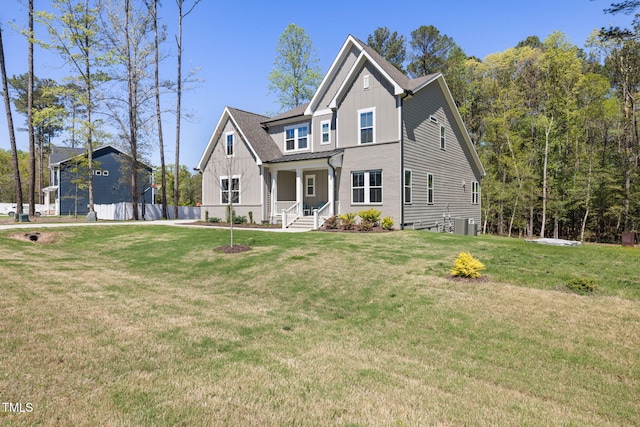 50 Gadwall Ct, Zebulon, NC 27597 - traditional-style house with board and batten siding, a porch, a front yard, central AC, and fence