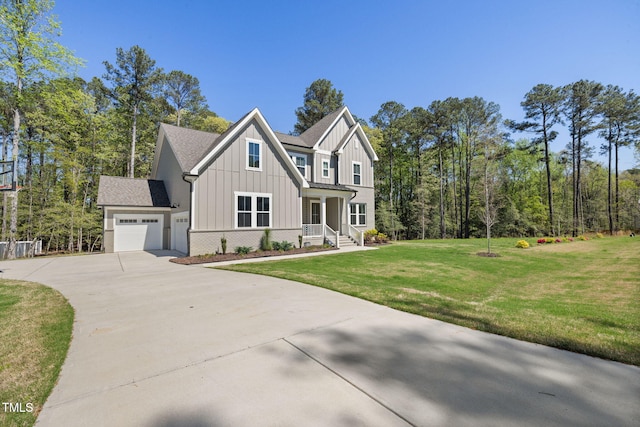 50 Gadwall Ct, Zebulon, NC 27597 - view of front of home with a front lawn, covered porch, board and batten siding, concrete driveway, and an attached garage