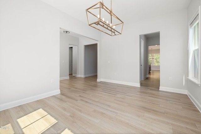 50 Gadwall Ct, Zebulon, NC 27597 - unfurnished room with an inviting chandelier, baseboards, and light wood finished floors