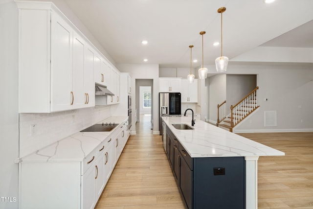 50 Gadwall Ct, Zebulon, NC 27597 - kitchen with recessed lighting, white cabinetry, under cabinet range hood, a sink, and light wood-style flooring