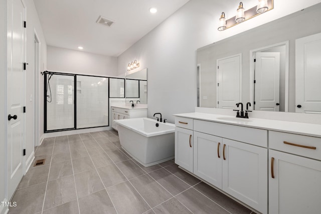50 Gadwall Ct, Zebulon, NC 27597 - full bath featuring a sink, visible vents, a soaking tub, and a stall shower