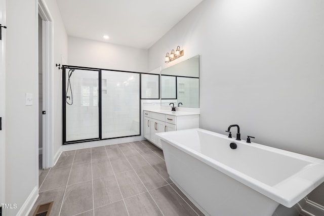 50 Gadwall Ct, Zebulon, NC 27597 - bathroom with visible vents, a freestanding tub, a stall shower, vanity, and recessed lighting