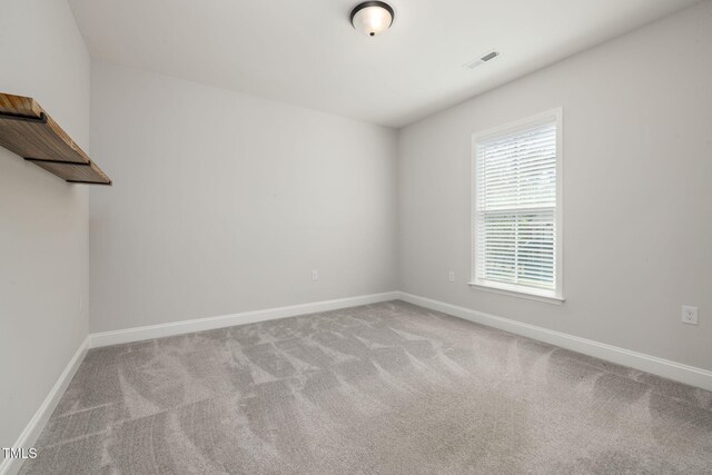 50 Gadwall Ct, Zebulon, NC 27597 - spare room with baseboards, visible vents, and carpet
