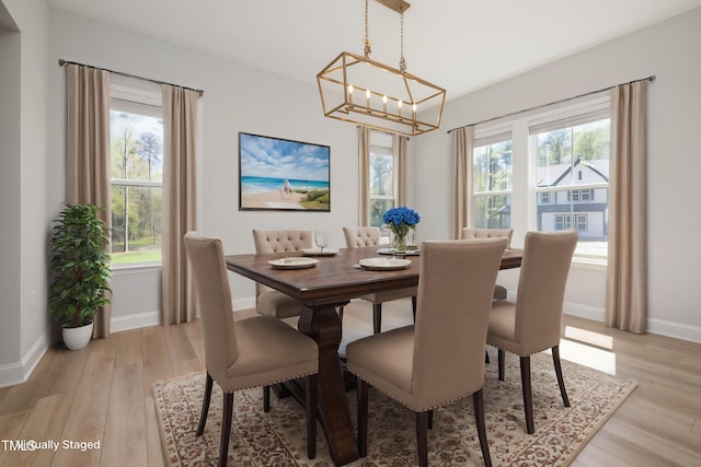 50 Gadwall Ct, Zebulon, NC 27597 - dining room featuring baseboards, a notable chandelier, and plenty of natural light