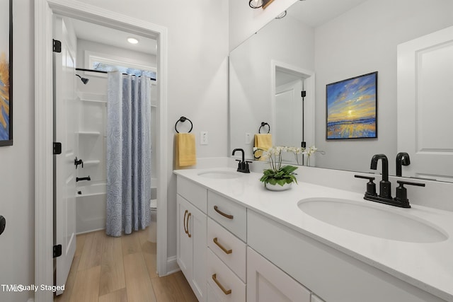 50 Gadwall Ct, Zebulon, NC 27597 - bathroom with a sink, double vanity, wood finished floors, and shower / bath combination with curtain