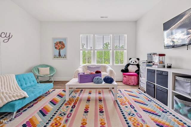game room with visible vents, baseboards, and light wood-style floors