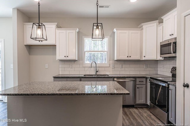 190 Love Grove Church Rd, West End, NC 27376 - kitchen featuring backsplash, a kitchen island, a sink, stainless steel appliances, and dark wood-type flooring