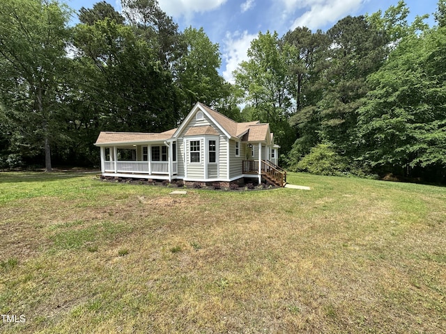 rear view of house with a lawn and covered porch