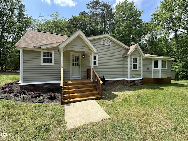 view of front facade with a shingled roof, crawl space, and a front lawn