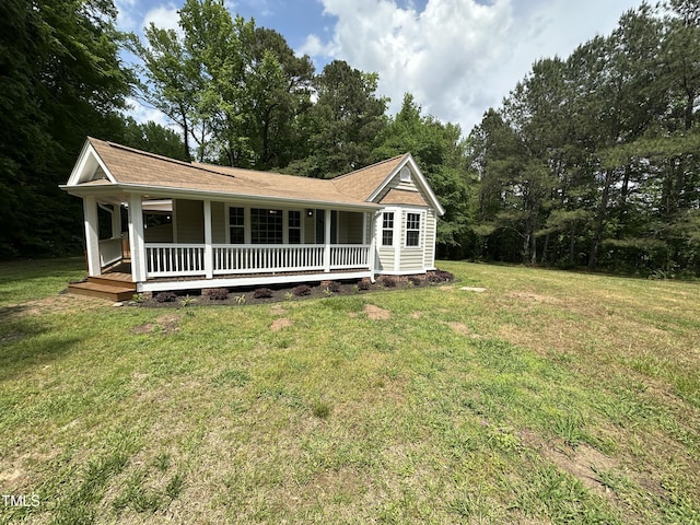 view of front of house with covered porch and a front yard