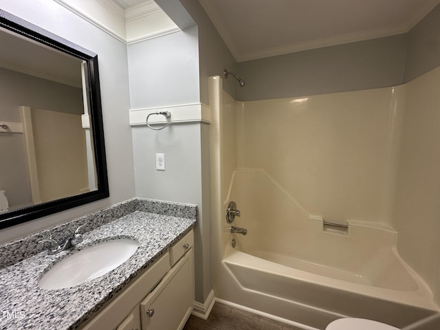 bathroom with crown molding, wood finished floors, bathtub / shower combination, and vanity