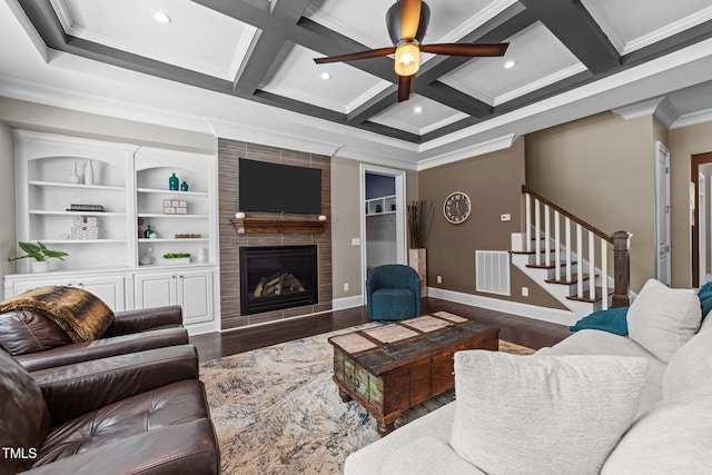 living area featuring stairs, visible vents, ornamental molding, and wood finished floors