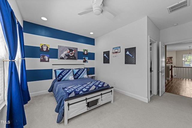 bedroom featuring visible vents, baseboards, carpet floors, and ceiling fan