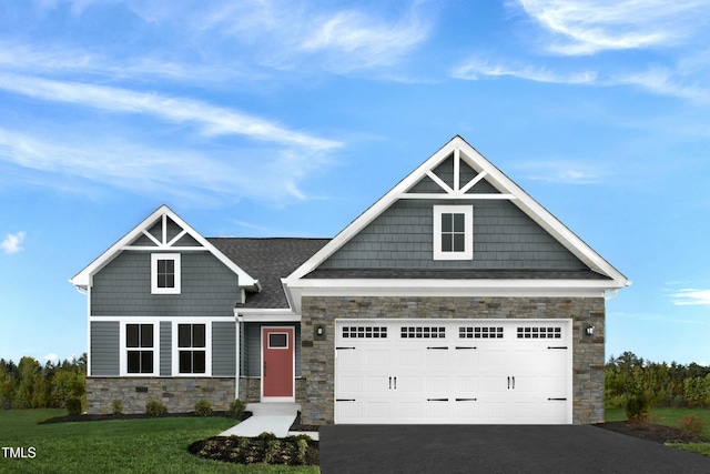 craftsman house featuring stone siding, driveway, a garage, and a front lawn