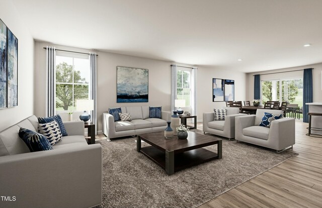 living room featuring wood finished floors and plenty of natural light