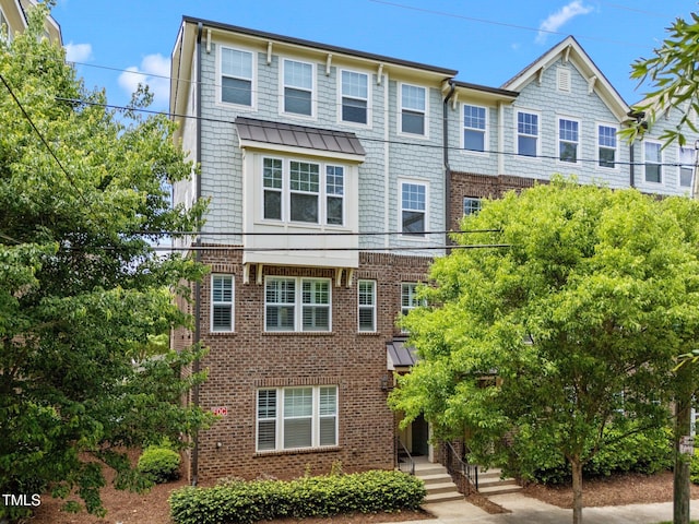 townhome / multi-family property with brick siding