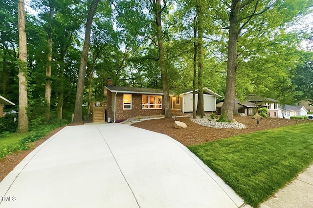 1124 Hardimont Rd, Raleigh, NC 27609 - view of front of property featuring brick siding, a storage unit, and a chimney