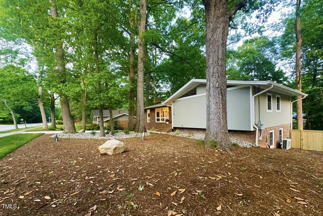 1124 Hardimont Rd, Raleigh, NC 27609 - view of home's exterior featuring brick siding and central AC