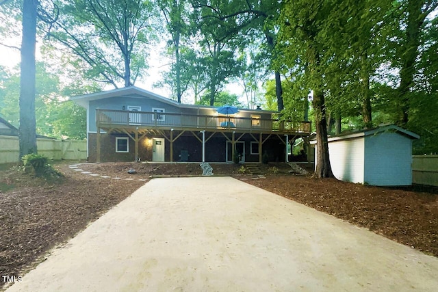 1124 Hardimont Rd, Raleigh, NC 27609 - view of front of house featuring fence, an outbuilding, a shed, and a wooden deck