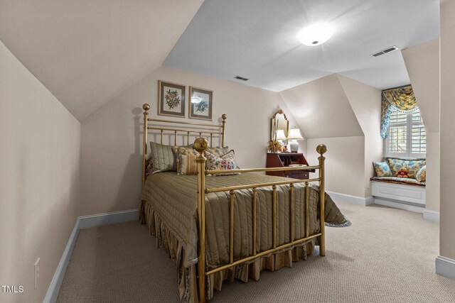 bedroom with baseboards, visible vents, carpet, and vaulted ceiling