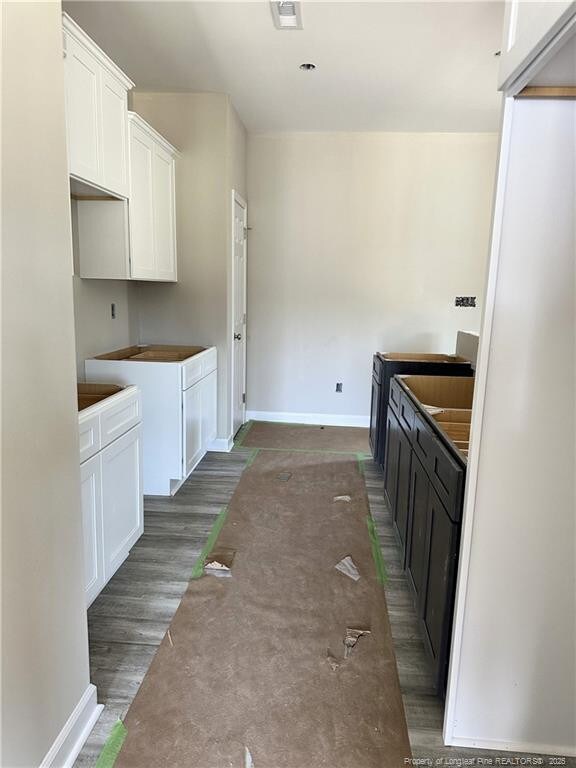 480 Dalton Dr, Lumber Bridge, NC 28357 - kitchen featuring white cabinets and baseboards
