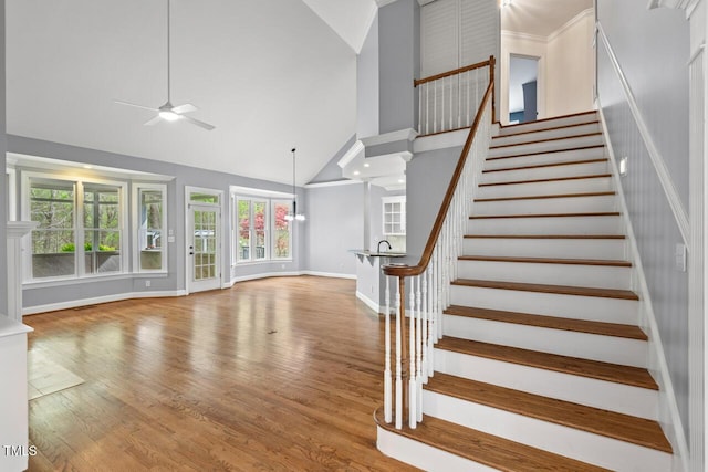 5900 Orchid Valley Rd, Raleigh, NC 27613 - stairway featuring high vaulted ceiling, baseboards, ceiling fan, and wood finished floors