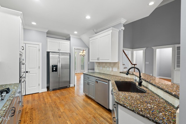 5900 Orchid Valley Rd, Raleigh, NC 27613 - kitchen featuring appliances with stainless steel finishes, a sink, crown molding, recessed lighting, and light wood-type flooring