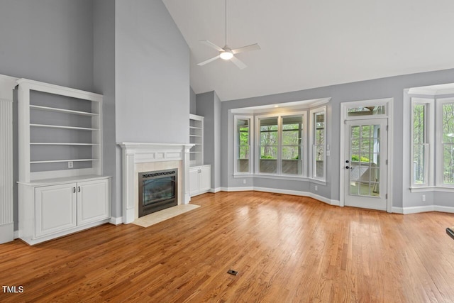 5900 Orchid Valley Rd, Raleigh, NC 27613 - unfurnished living room featuring high vaulted ceiling, a ceiling fan, a fireplace, wood finished floors, and baseboards