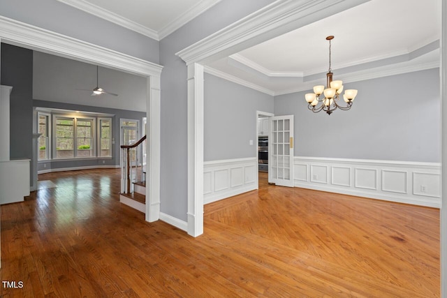5900 Orchid Valley Rd, Raleigh, NC 27613 - spare room featuring wood finished floors, a chandelier, a ceiling fan, ornamental molding, and stairway
