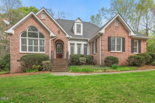 5900 Orchid Valley Rd, Raleigh, NC 27613 - traditional-style house with brick siding, a front lawn, and a shingled roof