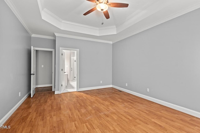 5900 Orchid Valley Rd, Raleigh, NC 27613 - unfurnished bedroom featuring a tray ceiling, light wood-type flooring, ornamental molding, baseboards, and ceiling fan